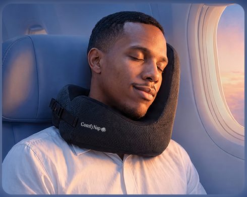 Chin resting on the front of the pillow while sitting upright