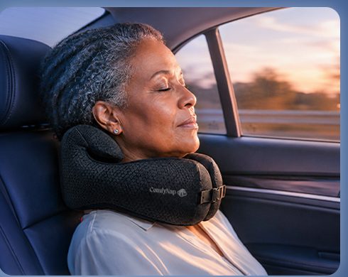 Passenger in a car seat with the pillow behind her head