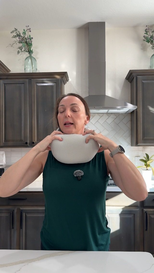 Video poster: traveler demonstrating the ComfyNap pillow in her kitchen